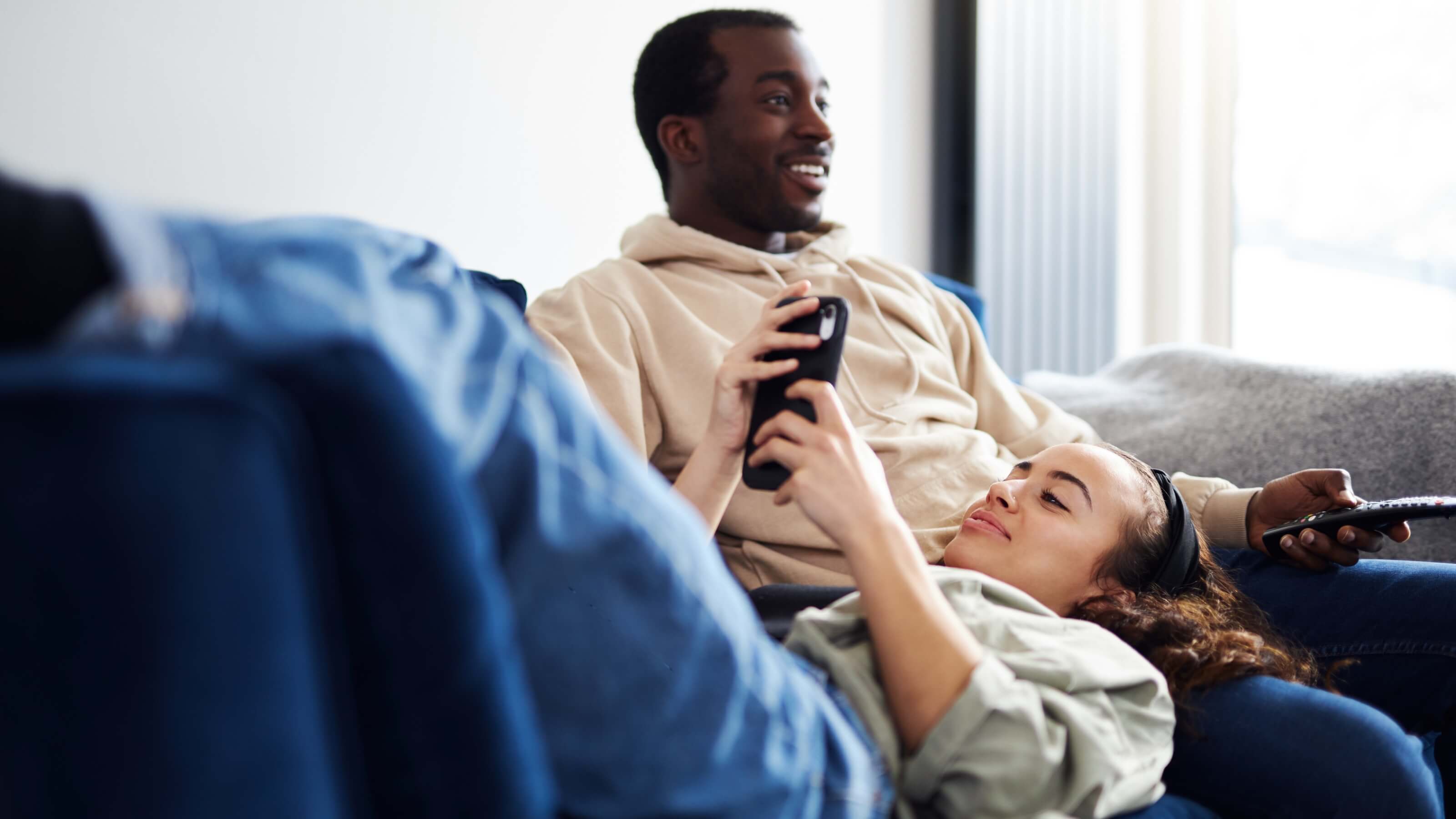 people sitting on a couch watching connected tv