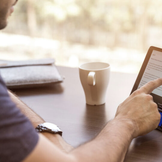 Man scrolling on tablet