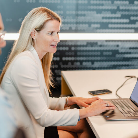 Photo of two colleagues reviewing a Privacy Sandbox demo on two computer screens