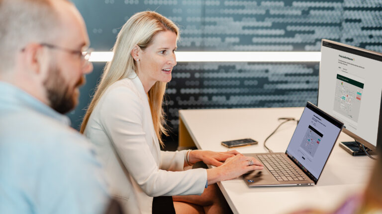 Photo of two colleagues reviewing a Privacy Sandbox demo on two computer screens