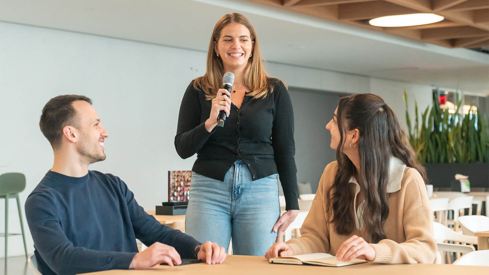 Woman asking question at company event