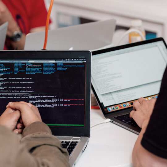 people sitting at a table working on laptops